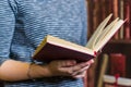 Opened red book in the hands of a girl. Soft focus Royalty Free Stock Photo