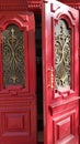 Entrance through ornate red door of historic building in European city Odessa of Ukraine Royalty Free Stock Photo