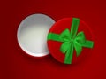 Opened red empty gift box with green ribbon and bow isolated on red background. Top view. Template for your presentation design, Royalty Free Stock Photo
