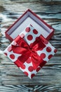 Opened red present box on vintage wooden board Royalty Free Stock Photo