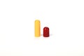 Opened red and yellow capsule isolated on a white background Royalty Free Stock Photo