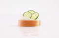 Opened sandwich appetizer with spread cheese cucumber topping low view