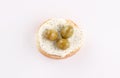 Opened sandwich appetizer with spread cheese olives topping top view