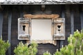 Opened shutters of aged wooden window on old chalet with copy space