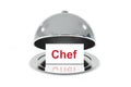 Opened silver cloche with white sign chef