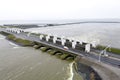 Opened sluices in a dyke draining water to the Waddenzee, Holland Royalty Free Stock Photo