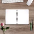 Opened spiral notebook with clean empty pages, flat lay on wooden background, styled mock up