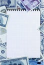 Opened spiral notepad on money background. stained blue. Royalty Free Stock Photo