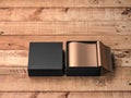Opened Square Black Gift Box Mockup with golden wrapping paper on wooden table, front Side View Royalty Free Stock Photo
