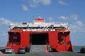 Opened stern ramp and doors of Festos Palace, cruise ferry with red and white hull.