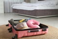 Opened suitcase with clothes and travel pillow Royalty Free Stock Photo