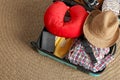 Opened suitcase with travel pillow and clothes Royalty Free Stock Photo