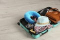 Opened suitcase with travel pillow and clothes Royalty Free Stock Photo