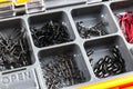 Opened tackle box with fishing hooks and accessories. Fishing hooks in box sections. Case for tackle elements. Fishing accessories