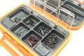 Opened tackle box with fishing hooks and accessories. Fishing hooks in box sections. Case for tackle elements. Fishing accessories