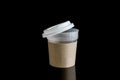 Opened take-out coffee with cup holder. Isolated on black background with Reflections Royalty Free Stock Photo