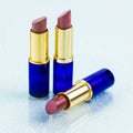 opened three rich red lipsticks with blue tubes Royalty Free Stock Photo