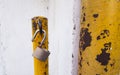 opened unlocked padlock on rusty yellow pole