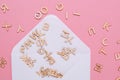 Opened white envelope with many abc letters on pink background