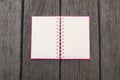 Opened white page of blank realistic spiral notepad notebook on wood texture background. Vintage style