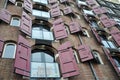 Opened windows of canal houses with red shutters, Amsterdam, Netherlands