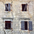 Opened windows of old ruined house