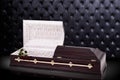 Opened wooden brown sarcophagus with a red roses isolated on gray luxury background. casket, coffin on royal background. Royalty Free Stock Photo