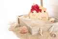 Opened wooden chest with gift box and two puzzle pieces, on sand Royalty Free Stock Photo