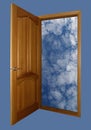 Opened wooden door with heaven on blue Royalty Free Stock Photo