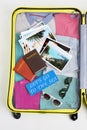 Opened yellow suitcase with accessories. Royalty Free Stock Photo
