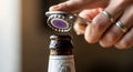 Opening a bottle of beer with a bottle opener close up Royalty Free Stock Photo