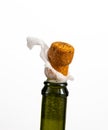 Opening a bottle of champagne, cork flyes out of the bottle with splashes Royalty Free Stock Photo