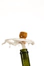 Opening a bottle of champagne, cork flyes out of the bottle with splashes Royalty Free Stock Photo