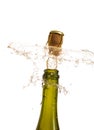 Opening a bottle of champagne, cork flyes out of the bottle with splashes Royalty Free Stock Photo