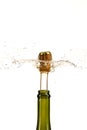 Opening a bottle of champagne, cork flyes out of the bottle with splashes Royalty Free Stock Photo