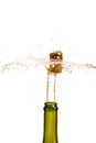 Opening a bottle of champagne, cork flyes out of the bottle with splashes Royalty Free Stock Photo