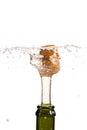 Opening a bottle of champagne, cork flyes out of the bottle with splashes Royalty Free Stock Photo