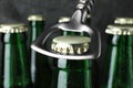 Opening bottle of tasty cold beer on grey background, closeup Royalty Free Stock Photo