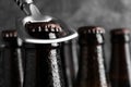 Opening bottle of tasty cold beer on grey background, closeup. Space for text Royalty Free Stock Photo