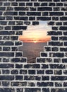 Opening in a brick wall, sunset on sea Royalty Free Stock Photo