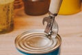 Opening canned corn with a special knife on canned wooden handle