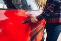 Opening car door. Woman opens red car with key Royalty Free Stock Photo