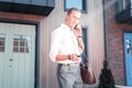 Handsome prosperous businessman opening his car while holding keys