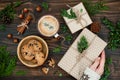 Opening Christmas present. Woman's hands holding decorated gift box on rustic wooden table. Ideal morning breakfast. Royalty Free Stock Photo