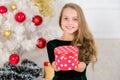 Opening christmas presents. Dreams come true. Best for our kids. Kid girl near christmas tree hold gift box. Child Royalty Free Stock Photo
