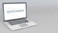 Opening and closing laptop with Bertelsmann logo. 4K editorial animation