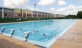 Opening day of the municipal swimming pool in Zamora, Spain with few people bathing.