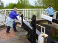 Couple opening canal lock gates