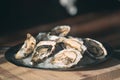 Opening the hollow and flat oysters. Chef opens oysters in the restaurant. Royalty Free Stock Photo