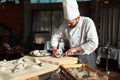 Opening the hollow and flat oysters. Chef opens oysters in the restaurant. Royalty Free Stock Photo